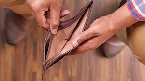 A man is holding an empty wallet
