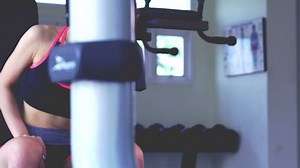 Young Asian woman workout exercising with dumbbells in the fitness gym