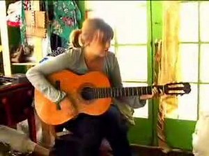 Girl Plays Guitar and Sings