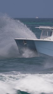 Invincible catamaran named Persistent cuts right through the wavy Haulover Inlet. | Joseph Levy