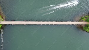 Minocqua Lake Bridge, Wisconsin; Aerial Birds Eye Static Drone Footage Over A Speedboat Zooming Across The Water.