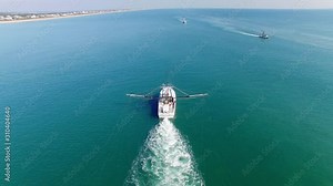 A White Trawling Shrimp Boat Cruises Off into the Horizon, Birds-Eye-View Steady Shot Stock Video
