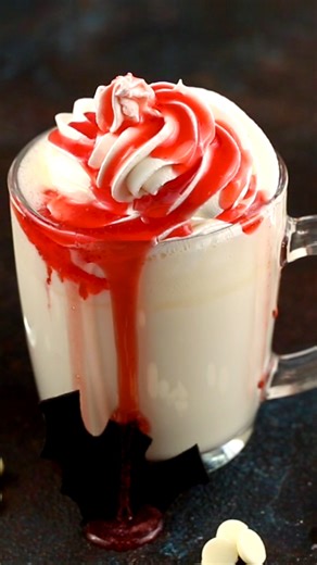 Warm up this Halloween night with our spine-tingling Vampire Blood White Hot Chocolate! Deliciously rich and creepy in appearance, it's the perfect treat to end your spooky evening. Delicious and rich white hot chocolate topped with lots of whipped cream and drizzled with gooey strawberry syrup. Don't let its creepy appearance fool you – this drink is devilishly delicious! #hotchocolate #halloweendrink Get the recipe: https://www.imperialsugar.com/recipes/vampire-blood-white-hot-chocolate | Impe