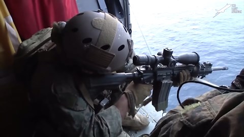 US sniper demonstrates precision by hitting moving targets from helicopter over water
