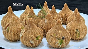 Ganesh Chaturthi-Besan Modak | Modak Recipe | Sunita Agarwal Ingredients Required- 1 cup gram flour 1/2 cup grated coconut 1/2 cup sugar 1 cup milk 2 tbsp desi ghee 2 tbsp fresh cream Sliced nuts #gramflour #modak #besanmodak #cooking #recipes | Sunita Agarwal