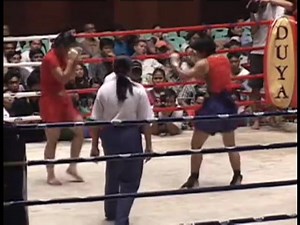 Women were not excluded from Lethwei competition and training. It was just the opportunities were far less for them. One of the first women I met was the Kyaw sisters in Mandalay. They trained very hard but were clearly frustrated by the lack of opportunity to get into the bigger shows. Here Thidar Kyaw, one of the sisters, competes again Kyu Kyu Tin in large arena bout. | Born warriors