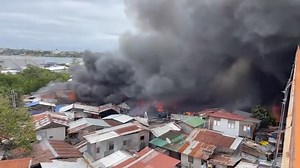 A fire broke out under the Mactan-Mandaue Bridge in Barangay Looc, Mandaue City, Cebu on Tuesday afternoon. A private tugboat was reported spraying water on the area. | via Romeo Marantal, The Freeman | Philippine Star