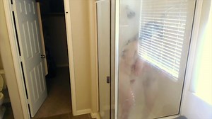 Hot guy with long hair shaves in the shower