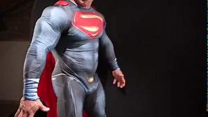 Bodybuilder as Superman strips naked.