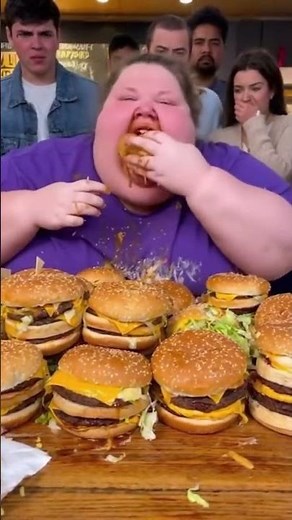 fat woman eating big hamburger