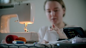 Woman sewing a protective mask for the pandemic - Free Stock Video