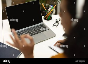 Black female teacher video calling via laptop and gesturing okay sign to computer empty screen, having online lesson Stock Photo - Alamy