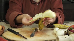 Woman Peeling Yellow Banana On Wooden Stock Footage SBV-348683293 - Storyblocks