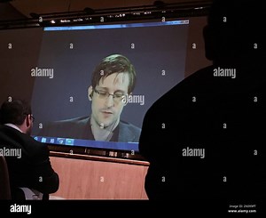 Former National Security Agency contractor Edward Snowden, center speaks via video conference to people in the Johns Hopkins University auditorium, Wednesday, Feb. 17, 2016, in Baltimore. Hopkins students spent months arranging the live video conference Wednesday night with Snowden, according to the Baltimore Sun. (AP Photo/Juliet Linderman Stock Photo - Alamy