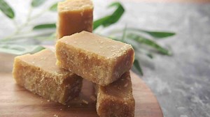 Jaggery traditional cane sugar cube on table .
