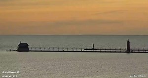 3.5K views · 82 reactions | Peaceful, orange glow of sunset over Lake Michigan in Grand Haven this evening. Calm waters allowing for a peaceful walk on the pier with temps holding at a comfortable 61 degrees. #PureMichigan | Great Lakes Weather & Climate | Facebook