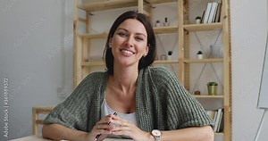 Smiling confident businesswoman hr applicant manager talk to camera having business videoconference conversation with distant client conference online video calling job interview look at webcam view