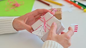 Female Hands Decorate An Original Wrapped Gift | Free Stock Video Footage