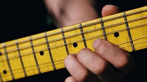 握住电吉他黄色指板上琴弦的手手指的特写。吉他手拉起琴弦独奏 库存影片视频（100% 免版税）3591088351 | Shutterstock