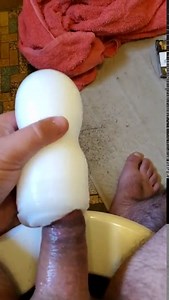 Man plays with tenga cup