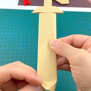 Title: "Simple Sword Origami Tutorial: Craft Your Own Weapon!" Hashtags: - #OrigamiTutorial - #HandmadeDIY - #ParentChildCrafts - #CreativeOrigami - #DIYCrafts | paper craft | Facebook