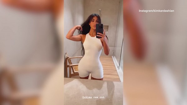 Kim Kardashian flaunts her bangs in a pink outfit before going to a Skims pop up