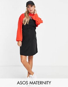 ASOS DESIGN Maternity tie waist nylon dungaree mini pinafore dress in black | ASOS