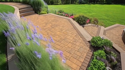 We’ve officially upgraded “staying in” by moving the living room outdoors—permanently. ✨ This multi-level patio brings it all: a cozy lounge, a built-in fire pit, and the kind of details that make every day feel like a getaway. With the lasting color of ArmorTec® pavers, your space stays vibrant and beautiful for every season. #CambridgePavers #OutdoorLiving #BackyardDesign #PaverPatio #HardscapeDesign #PatioGoals | Cambridge Pavingstones With ArmorTec | Facebook