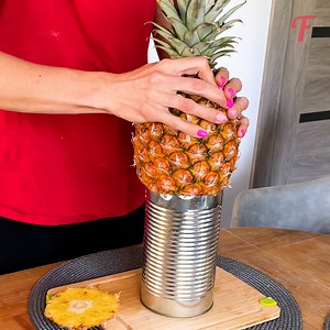 Woman makes quick work of a pineapple using a tin can. | Fabiosa Fitness