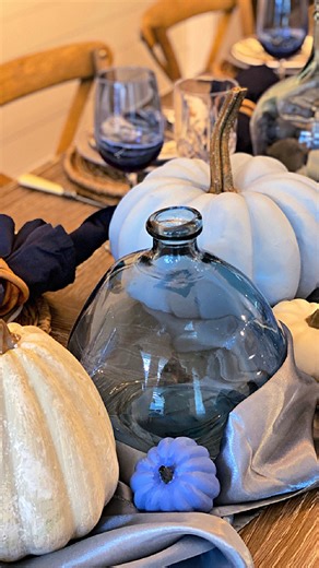 A fall look doesn’t always have to be oranges and rusts and reds. A fall table in shades of blue is a nice change. I painted some faux pumpkins in shades of blue to coordinate with the plates featuring blue and white pumpkins. Would you consider decorating a fall table in shades of blue? #tablescape #tablesetting #falltable #falltablesetting | Celebrate & Decorate