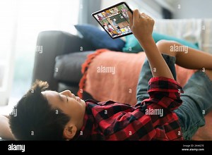 Asian boy using tablet for video call, with smiling diverse elementary school pupils on screen. communication technology and online education, digital Stock Photo - Alamy
