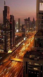 A stunning cityscape at dusk with glowing skyscrapers shining in the vibrant evening light