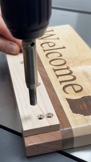 Closer look at my pilot hole jig in action! I made this jig to simplify the process of adding hooks to these key holders! In order to ensure that each pilot hole is in the exact correct place and depth, I used a self centering bit lined up inside of each countersunk jig hole. With this setup it was very easy to bust out over 200 holes in about 10 minutes! I even figured out after the first couple that I didn’t need to clamp the jig on each time as long is a held it securely on a hard flat surfac