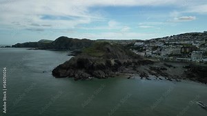 Aerial orbit shot of Capstone Hill in Ilfracombe, North Devon, UK with views of the coastal town.