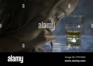 Close-up female snorting cocaine line on mirror Stock Video Footage - Alamy