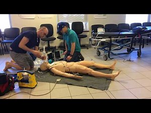 Paramedic demonstrates treatment of adult choking (complete foreign body airway obstruction)