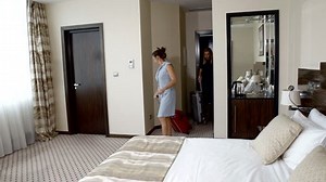 clip-1026070289-two-girls-lesbian-checking-hotel-room-vacation