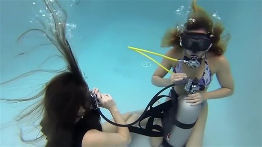 Girls sharing air underwater