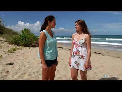 Lesbian kiss between two women on a remote beach