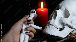 Fortune telling on the dark tarot, holding a seance of spiritualism. Burning red and black candles. An ominous situation in the frame.