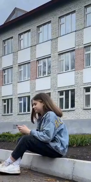 Casual Conversation on the Curb: Denim and Red Hoodie