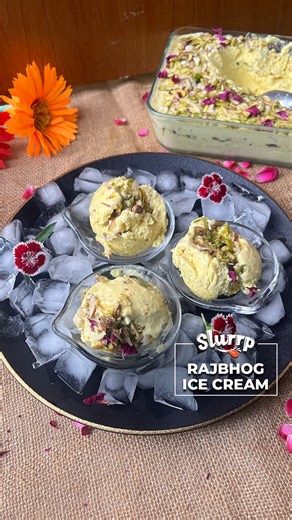 RAJBHOG ICE CREAM This velvety and rich creamy ice-cream loaded with nuts and saffron gives you an authentic flavour of the most famous Indian sweet - RAJBHOG! #slurrpcommunity member Sonia Sarpal simplifies this royal treat that anyone can make at home. Ingredients: 500 ml milk 1/2 cup powdered sugar 1/2 cup milk powder Custard Mix: 50 ml milk 2 tbsp custard powder 150 g khoya 3/4 cup crushed nuts( almonds, pistachios,cashews) Saffron soaked in milk ( good quantity) 1 tbsp cardamom powder 200 m