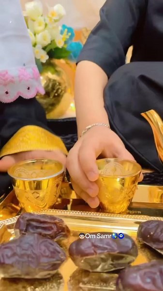 Traditional Attire Showcase with Golden Cups and Decor