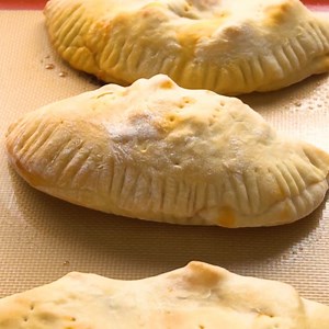 This Homemade Calzone Recipe is so fun to make with your family. An easy dough and sauce combined with lots of gooey cheese and favorite pizza toppings make this a simple supper everyone will be happy to help prepare! https://www.favfamilyrecipes.com/calzones/ | Favorite Family Recipes