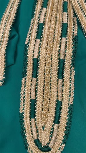 Intricate Green and Gold Embroidery on Textile Fabric