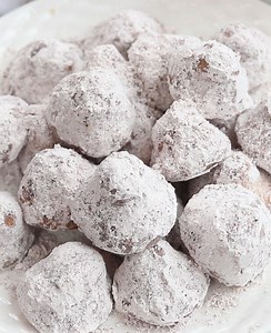 Melt-in-your-mouth soft butter cookies tossed in cocoa and powdered sugar. https://valentinascorner.com/truffle-cookie-kisses/ | Valentina's Corner