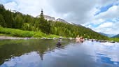 Woman and man panning shot of romantic couple swimming inside hot...