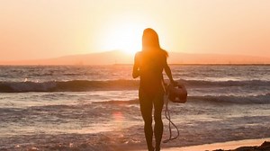 clip-1040849411-female-lifeguard-running-along-beach