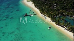 Beach along the waterfront and coral reef and palm trees, Mauritius, Africa, Pier near the beach of the island of Mauritius