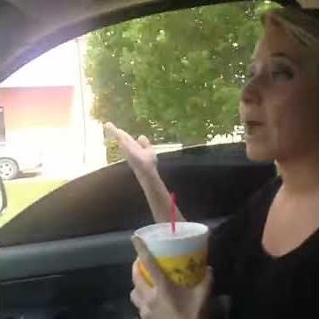 girl littering car window